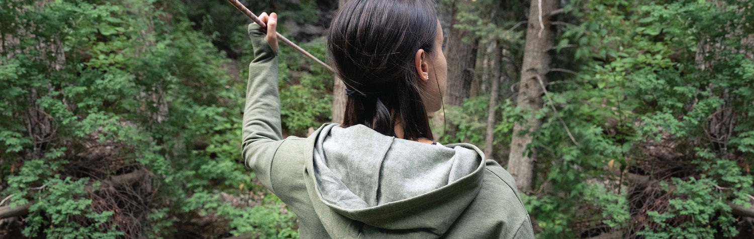 Female Model wearing GOEX Ladies Fleece Hoodie in Olive while Slack-Lining