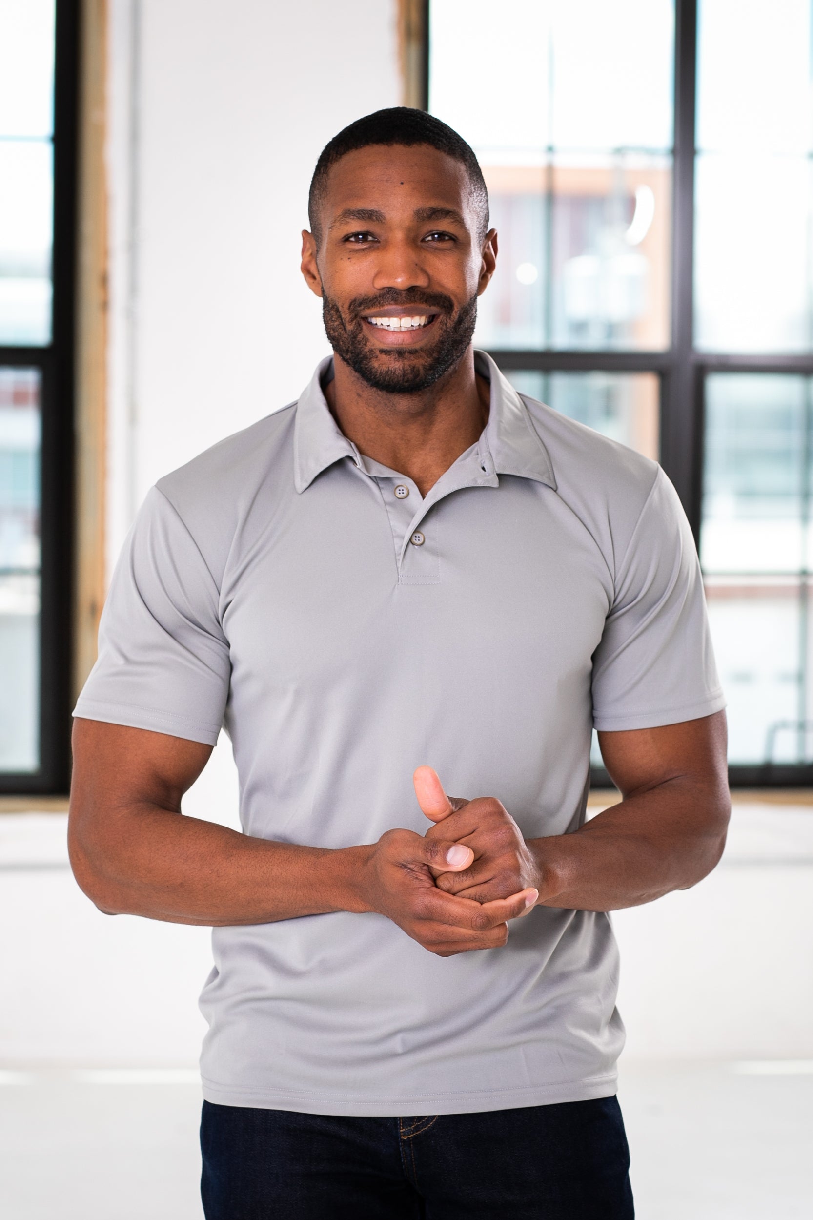 Male Model wearing GOEX Unisex and Men's Eco Poly Polo in Cool Grey