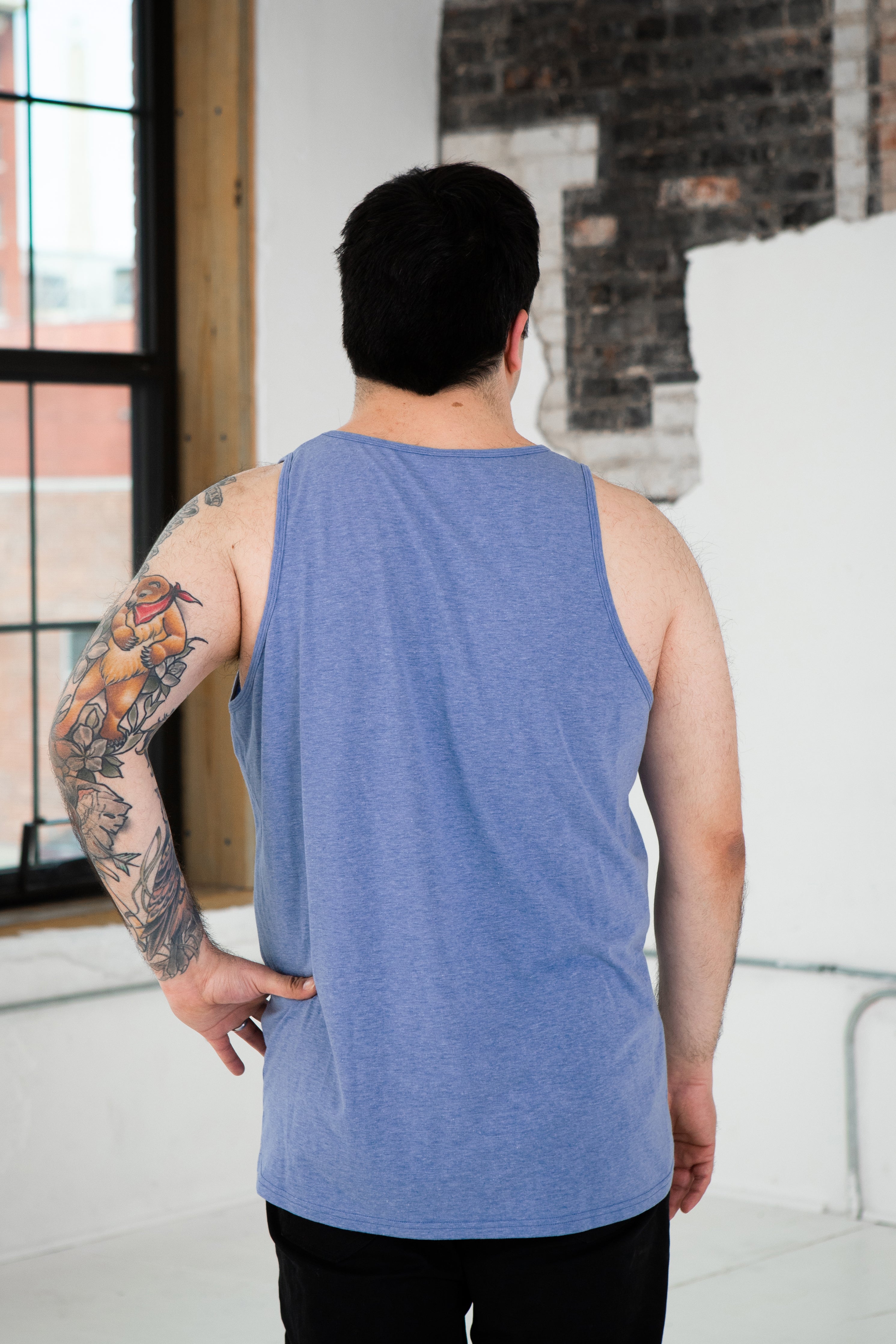 Back View of Male Model wearing GOEX Unisex and Men's Eco Triblend Tank in Light Blue