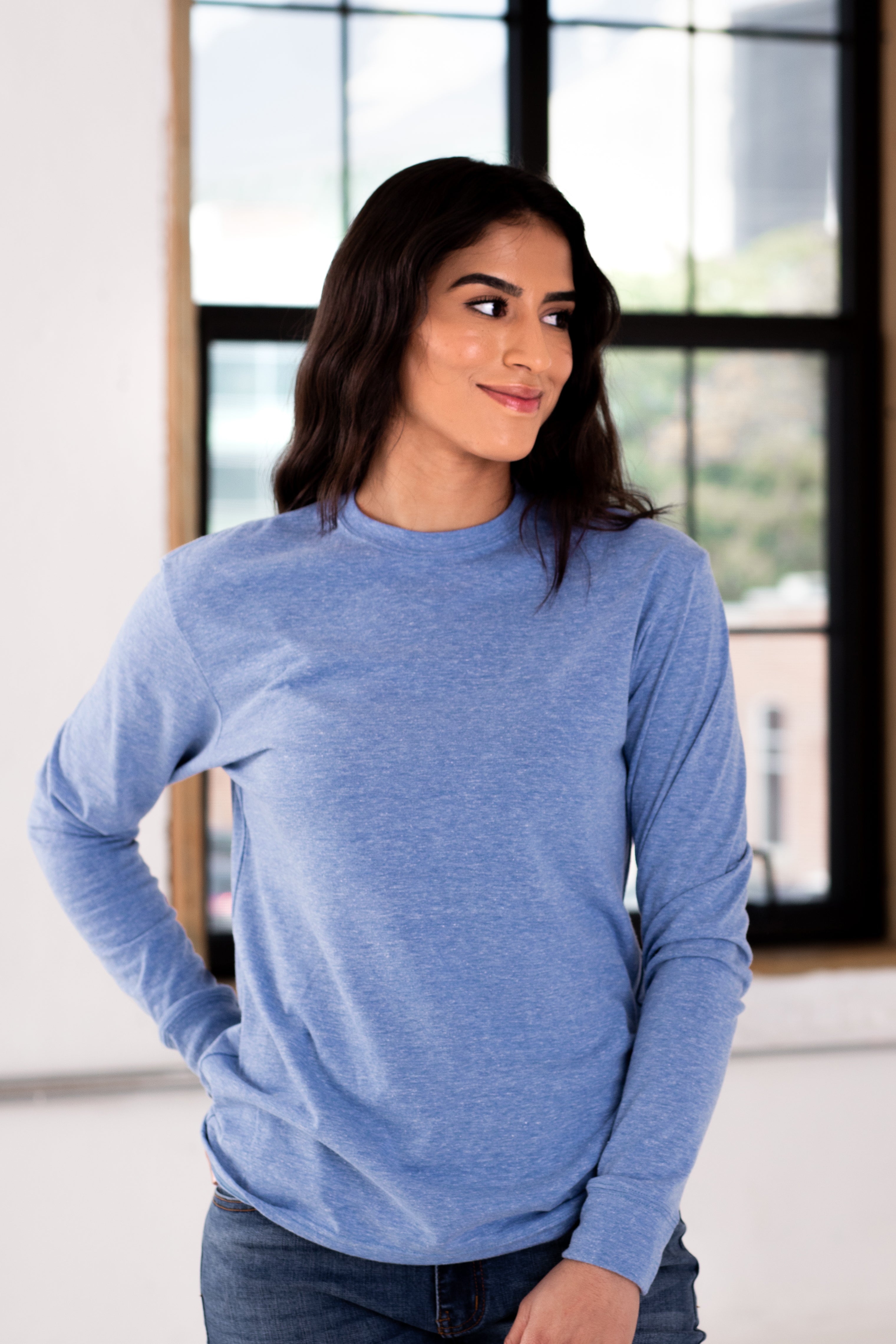 Female Model wearing GOEX Unisex and Men's Eco Triblend Long Sleeve Tee in Light Blue