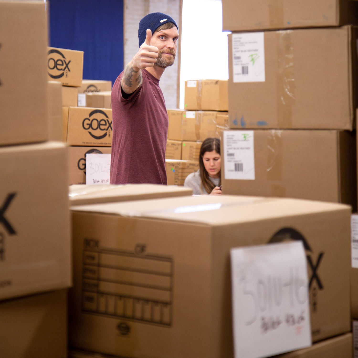 Man with Thumbs Up working in a warehouse