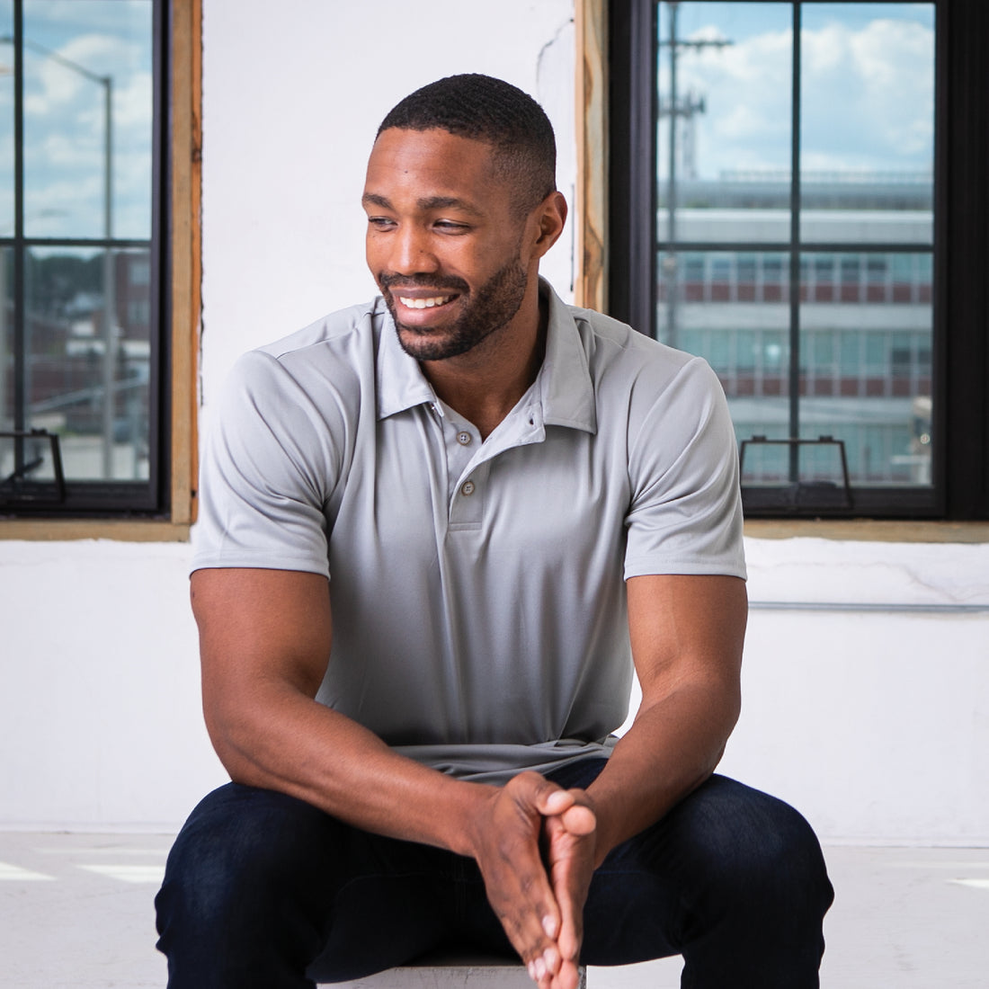 Male Model wearing GOEX Unisex and Men's Eco Poly Polo in Cool Grey