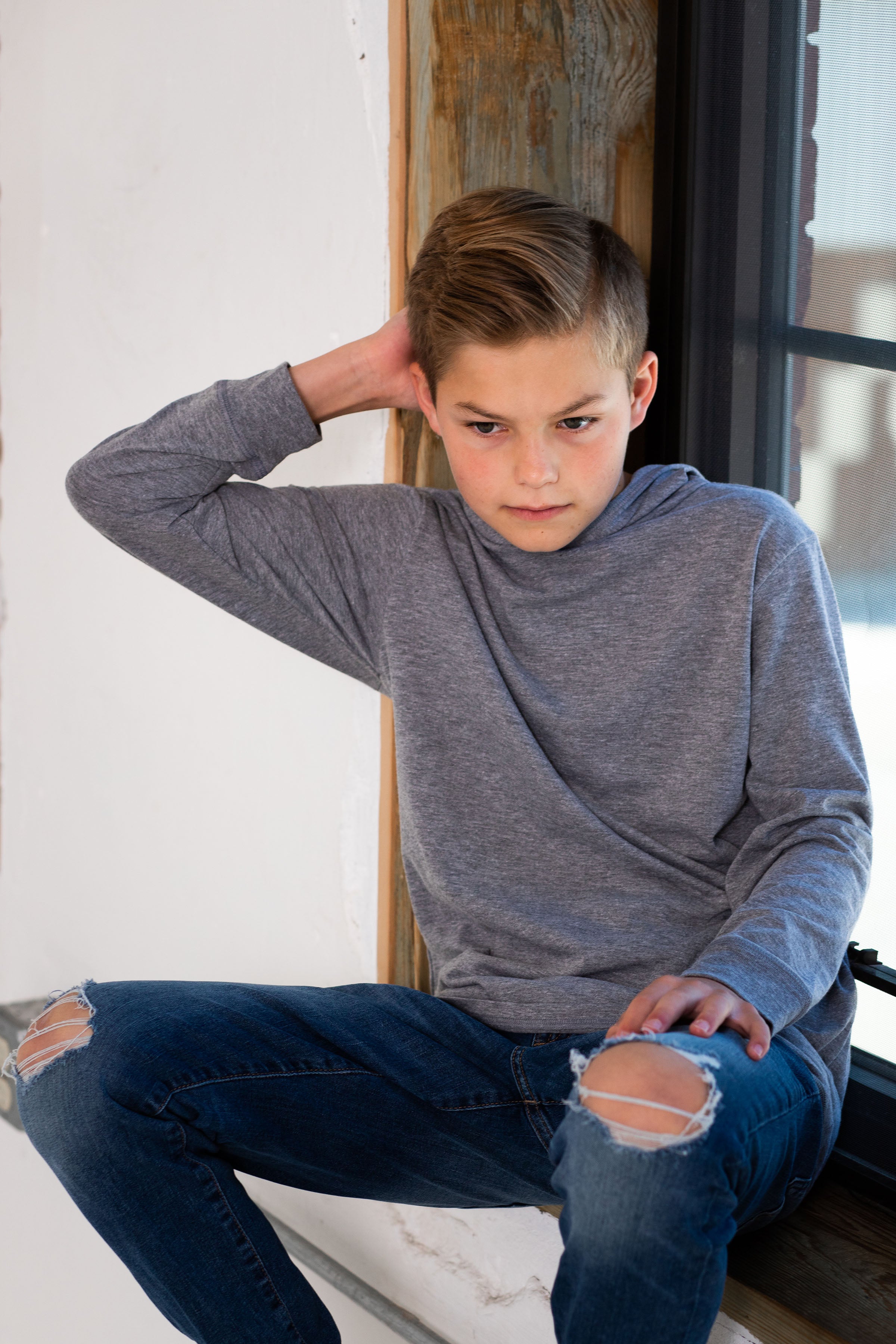 Boy Model wearing GOEX Youth Eco Triblend LS Hooded Tee in Heather Grey