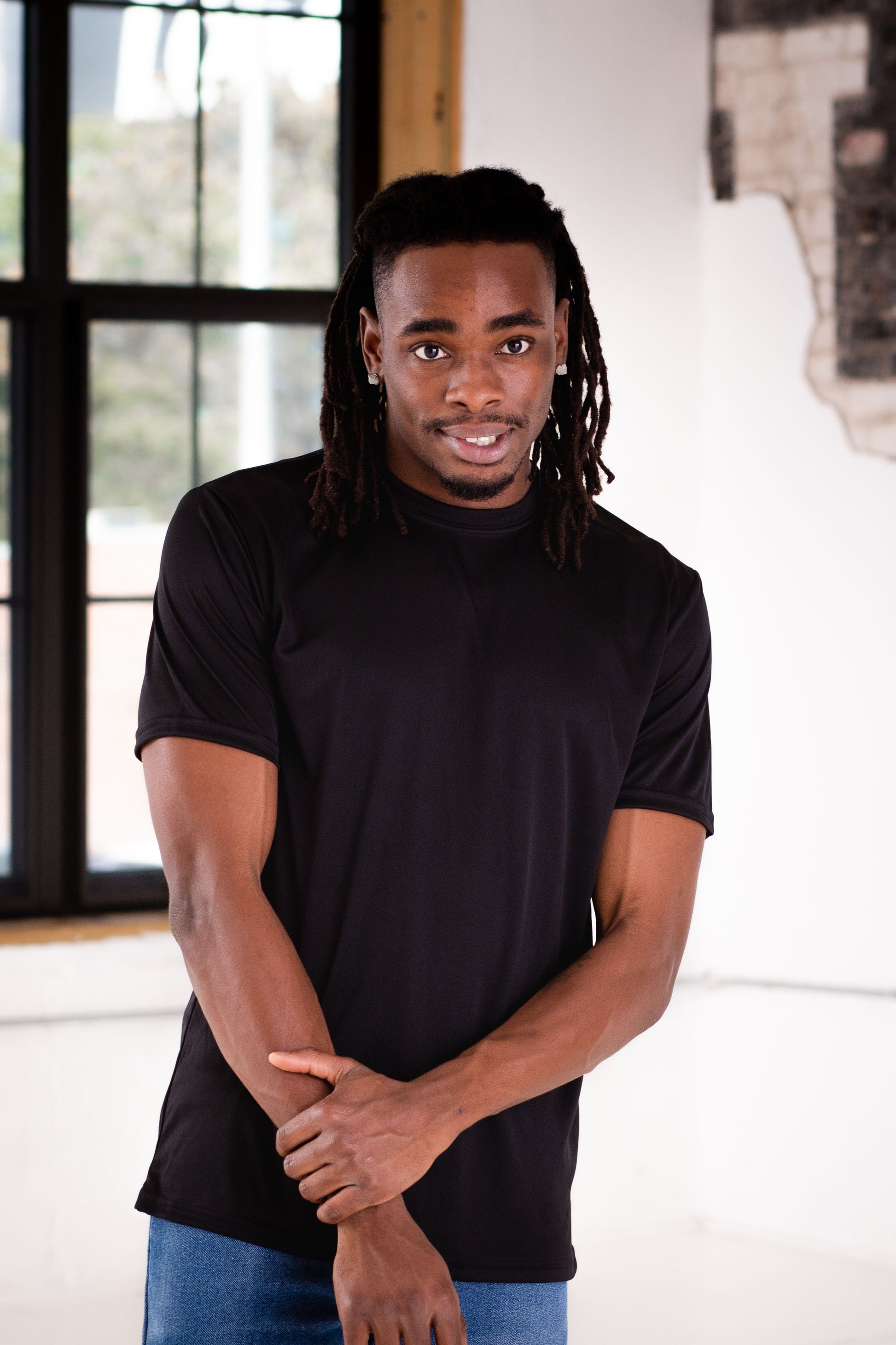 Male Model wearing GOEX Unisex and Men's Eco Poly Tee in Black