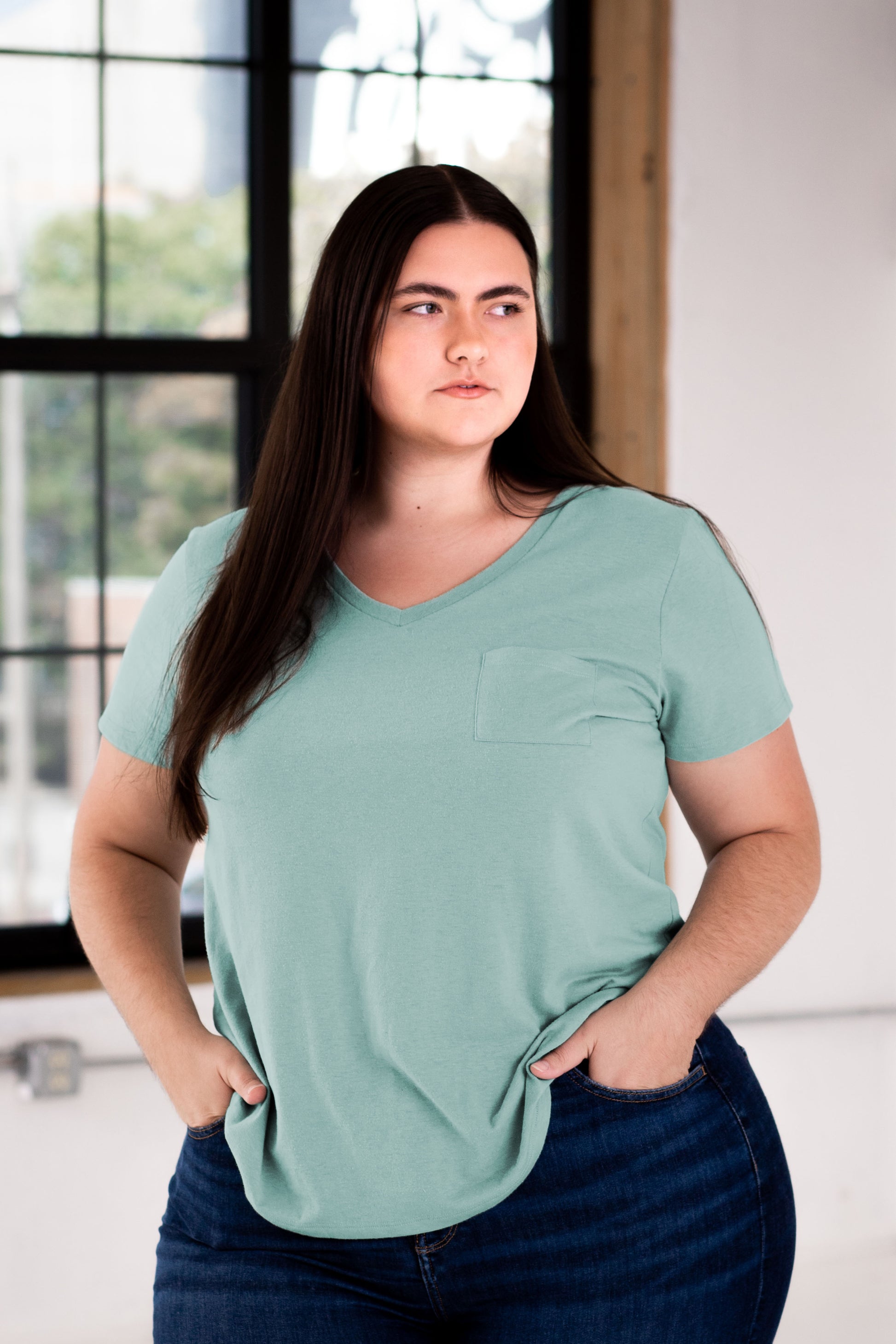 Female Model wearing GOEX Ladies Eco Triblend Drop Hem Pocket Tee in Sage