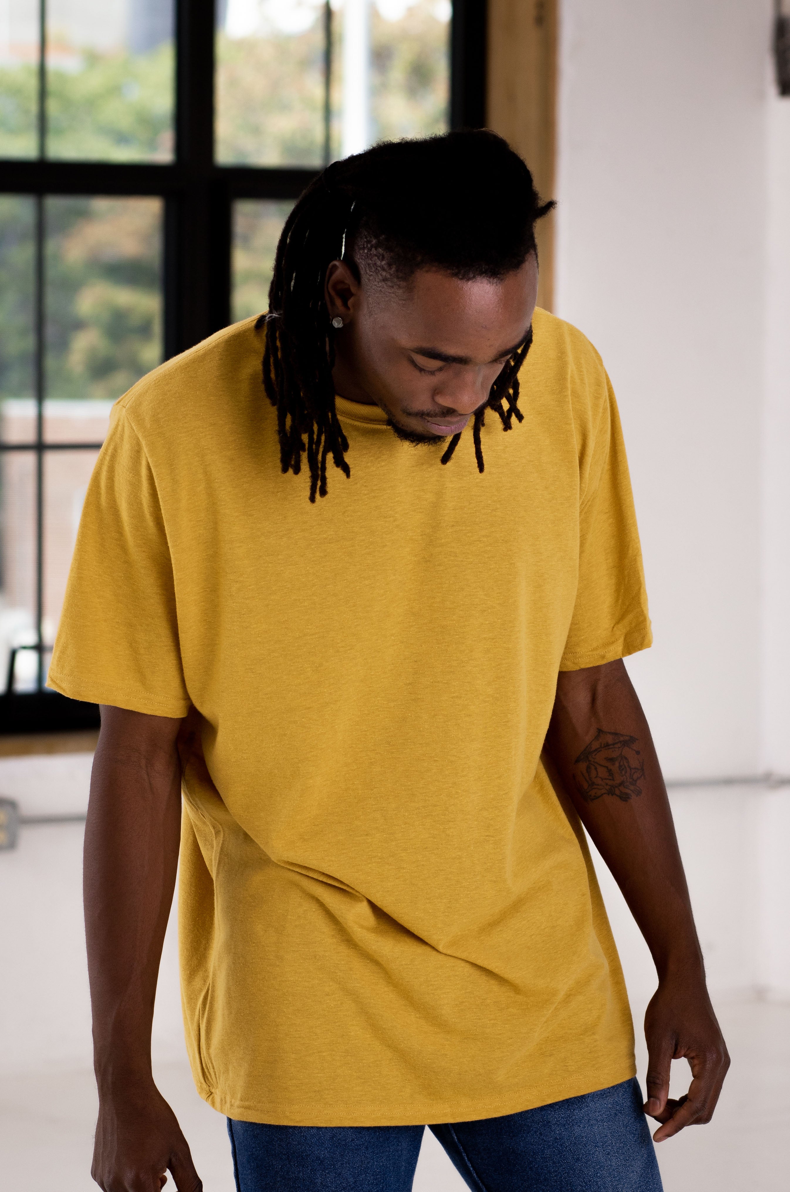 Male Model wearing GOEX Eco Triblend Unisex and Mens Tee in Mustard