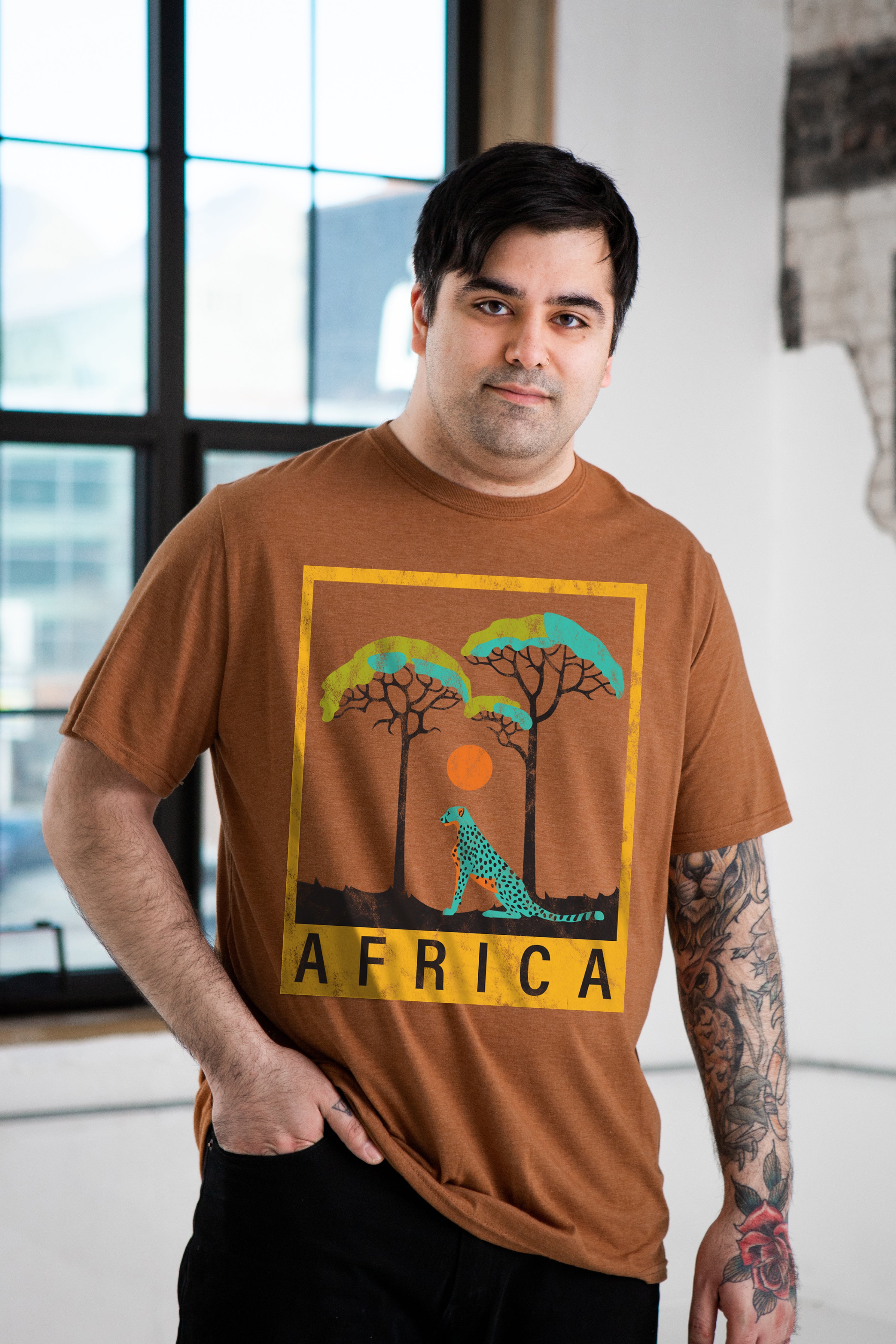 Male Model wearing GOEX Unisex and Men's Africa Eco Triblend Graphic Tee in Amber