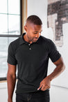 Male Model wearing GOEX Unisex and Men's Eco Triblend Polo in Charcoal
