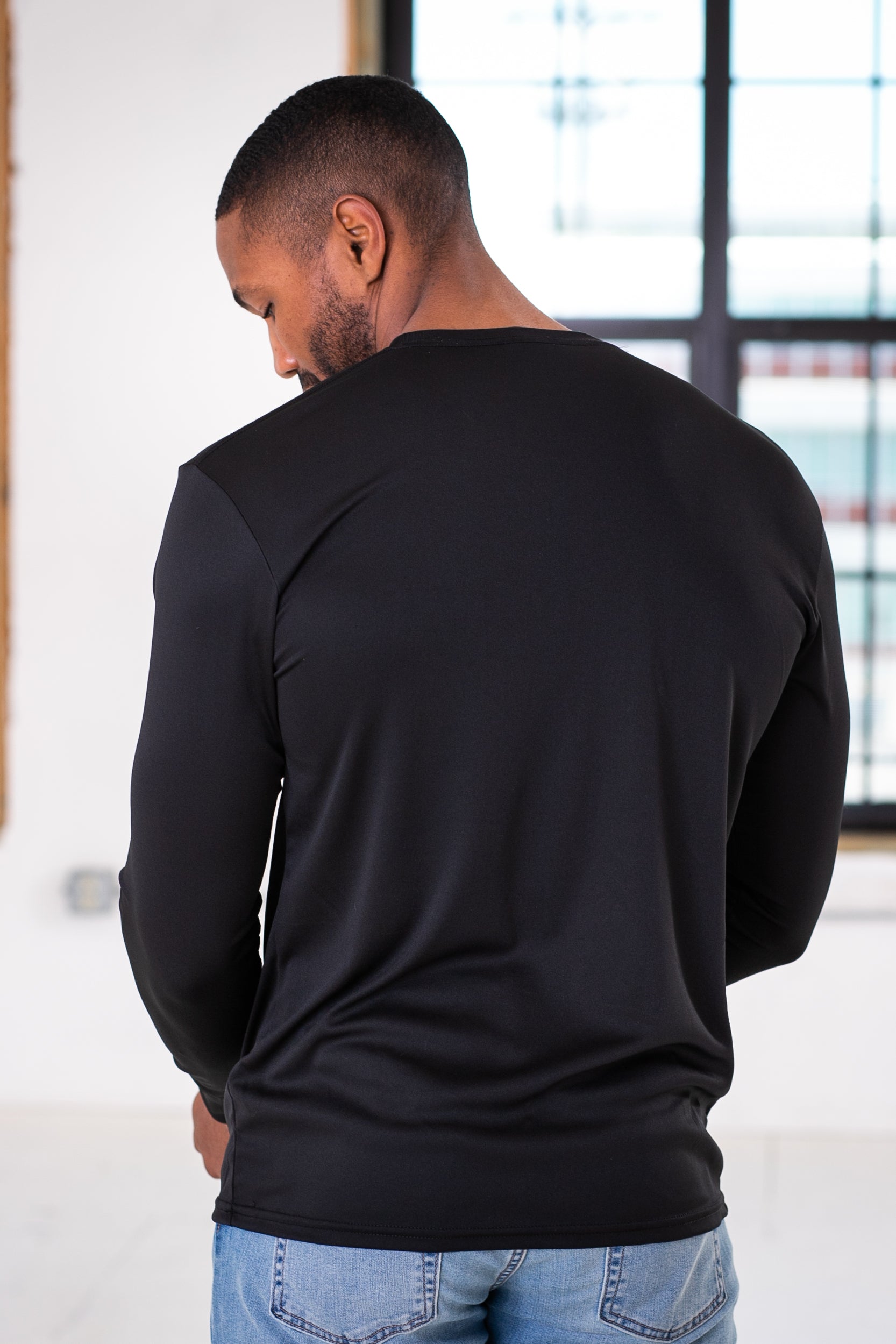 Back view of Male Model wearing GOEX Unisex and Men's Eco Poly LS Tee in Black