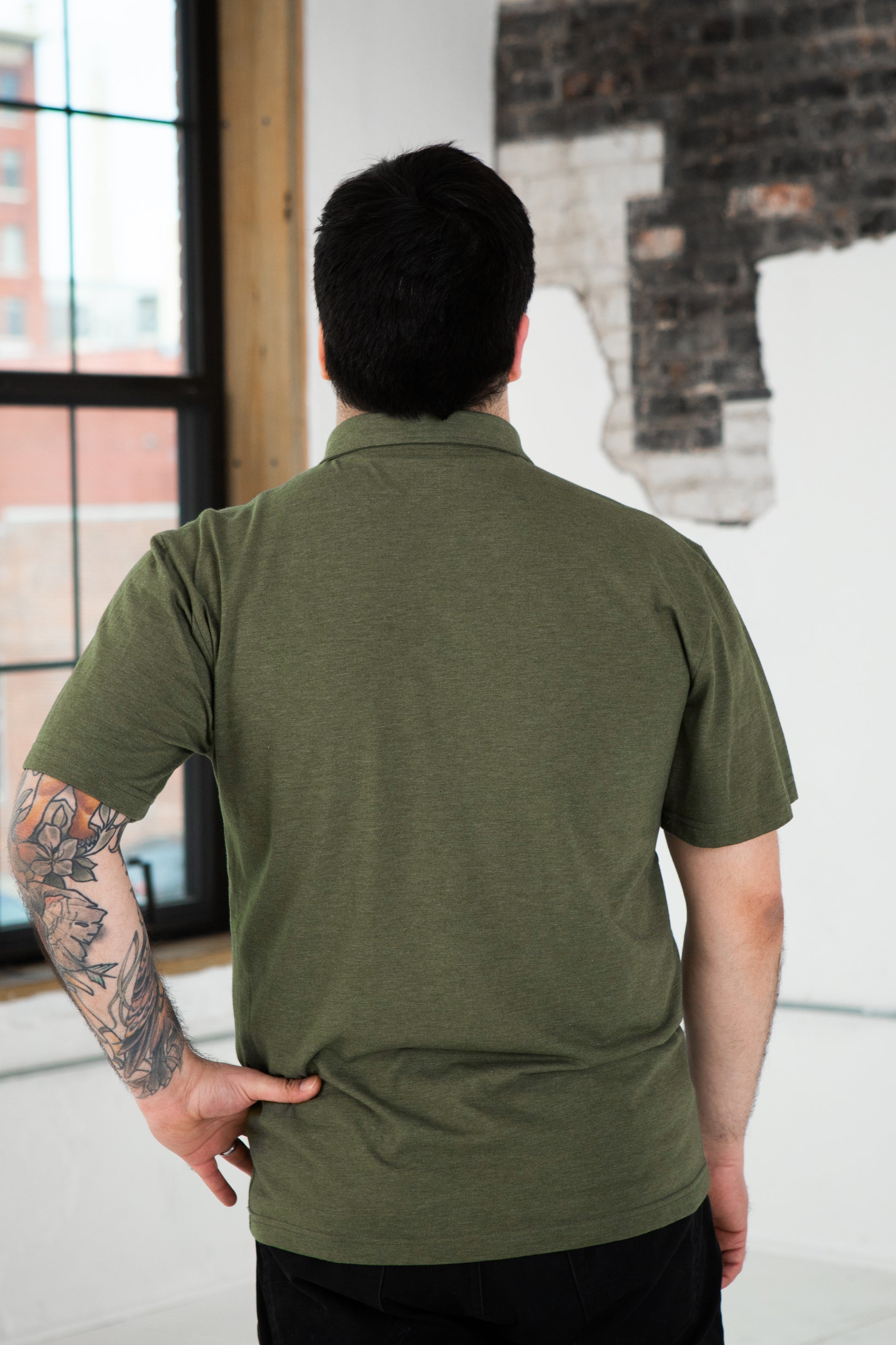 Back View of Male Model wearing GOEX Unisex and Men's Eco Triblend Polo in Olive