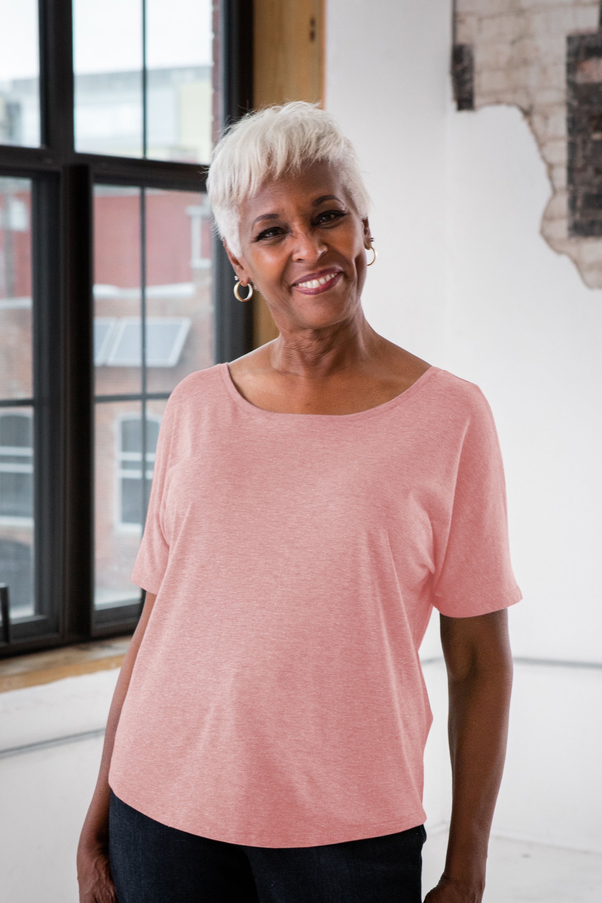 Female Model wearing GOEX Ladies Eco Triblend Flowy Tee in Rose