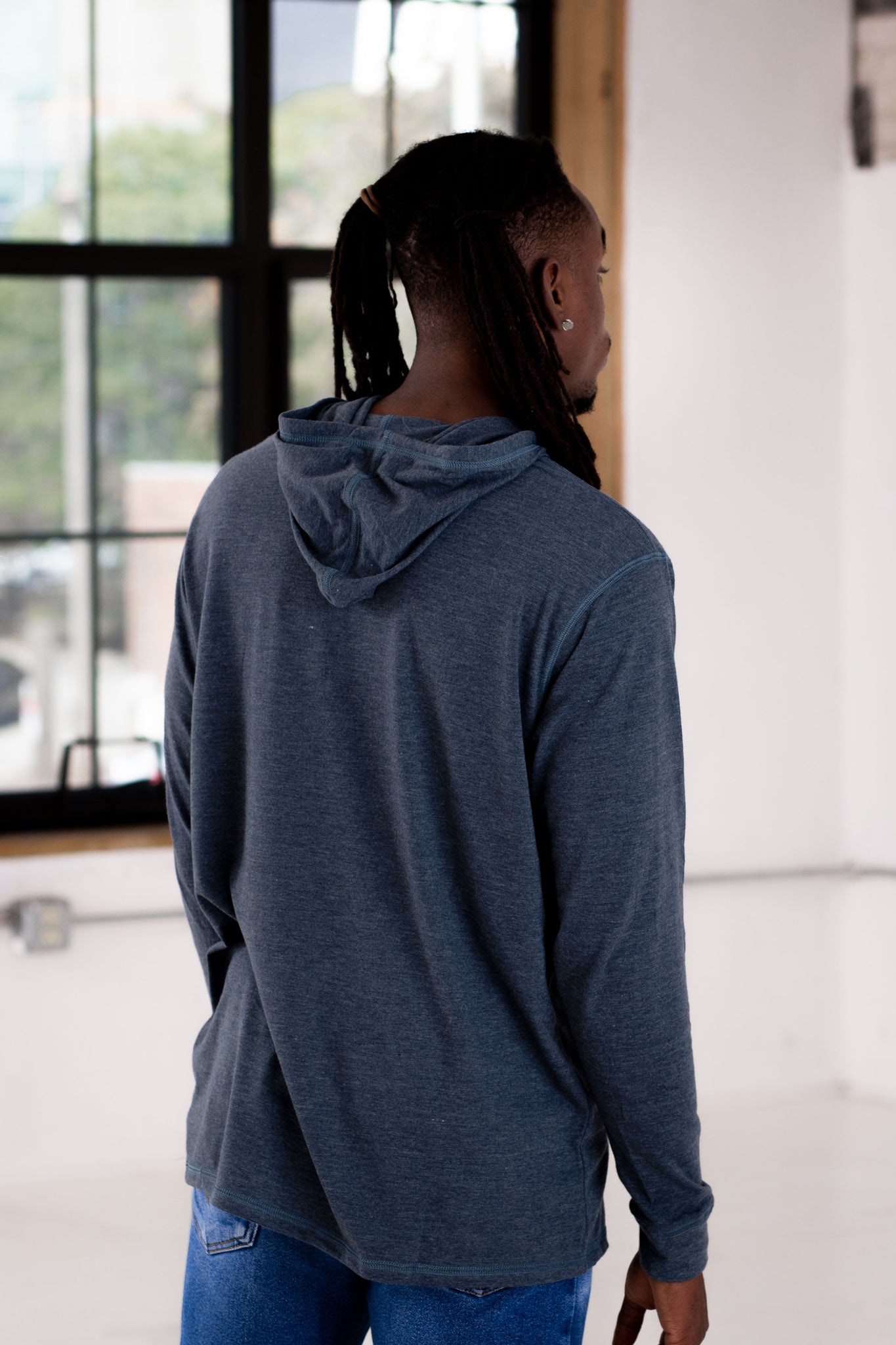 Back View of Male Model wearing GOEX Unisex and Men's Eco Triblend Hooded Tee in Navy