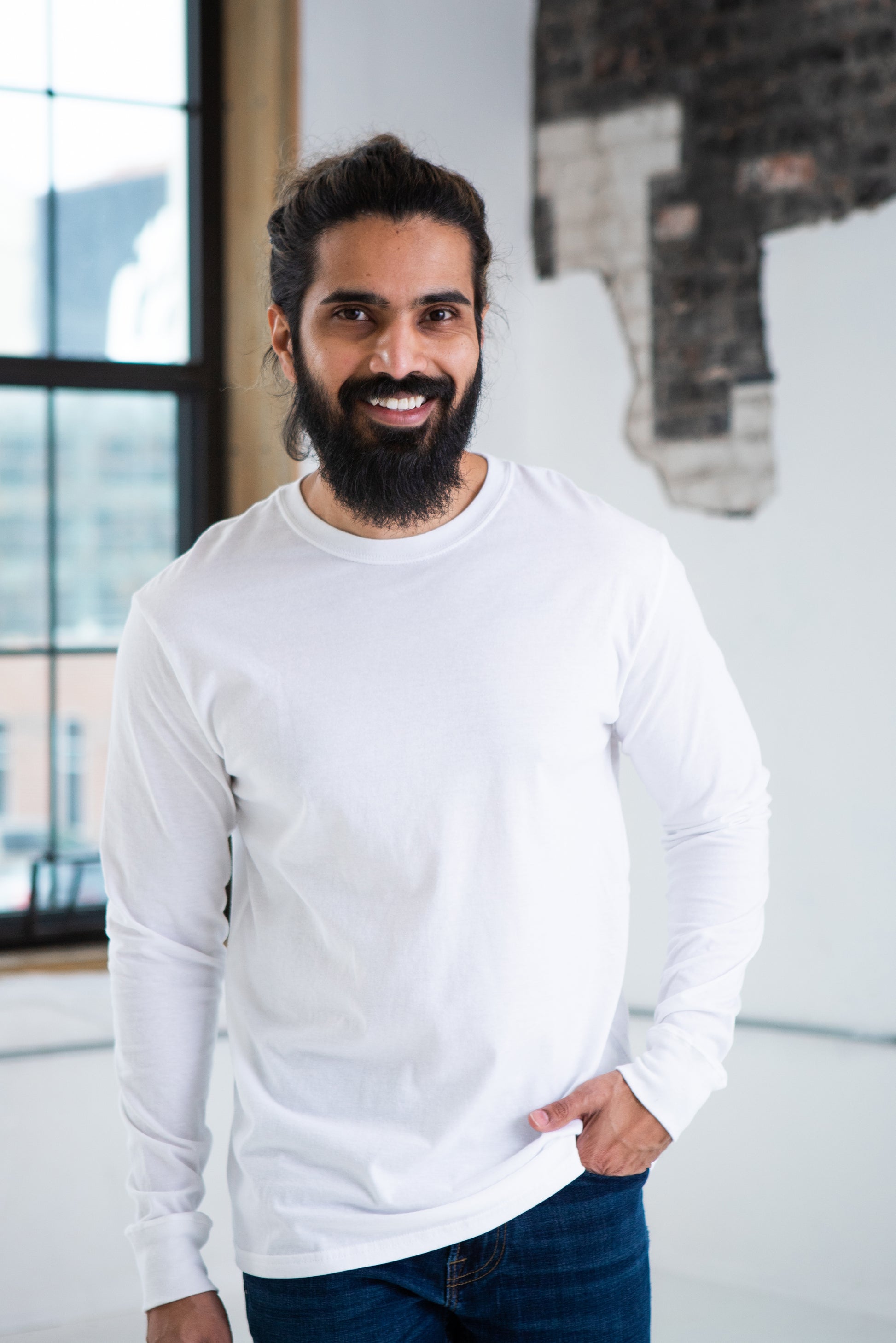 Male Model wearing GOEX Unisex and Men's Premium Cotton LS Tee in White