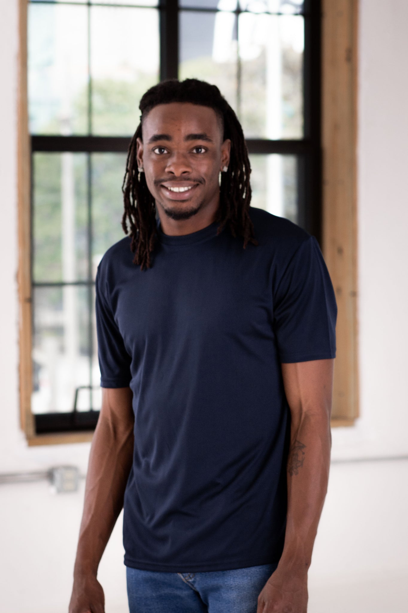 Male Model wearing GOEX Unisex and Men's Eco Poly Tee in Navy