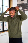 Male Model wearing GOEX Unisex and Men's Eco Triblend Hooded Tee in Olive