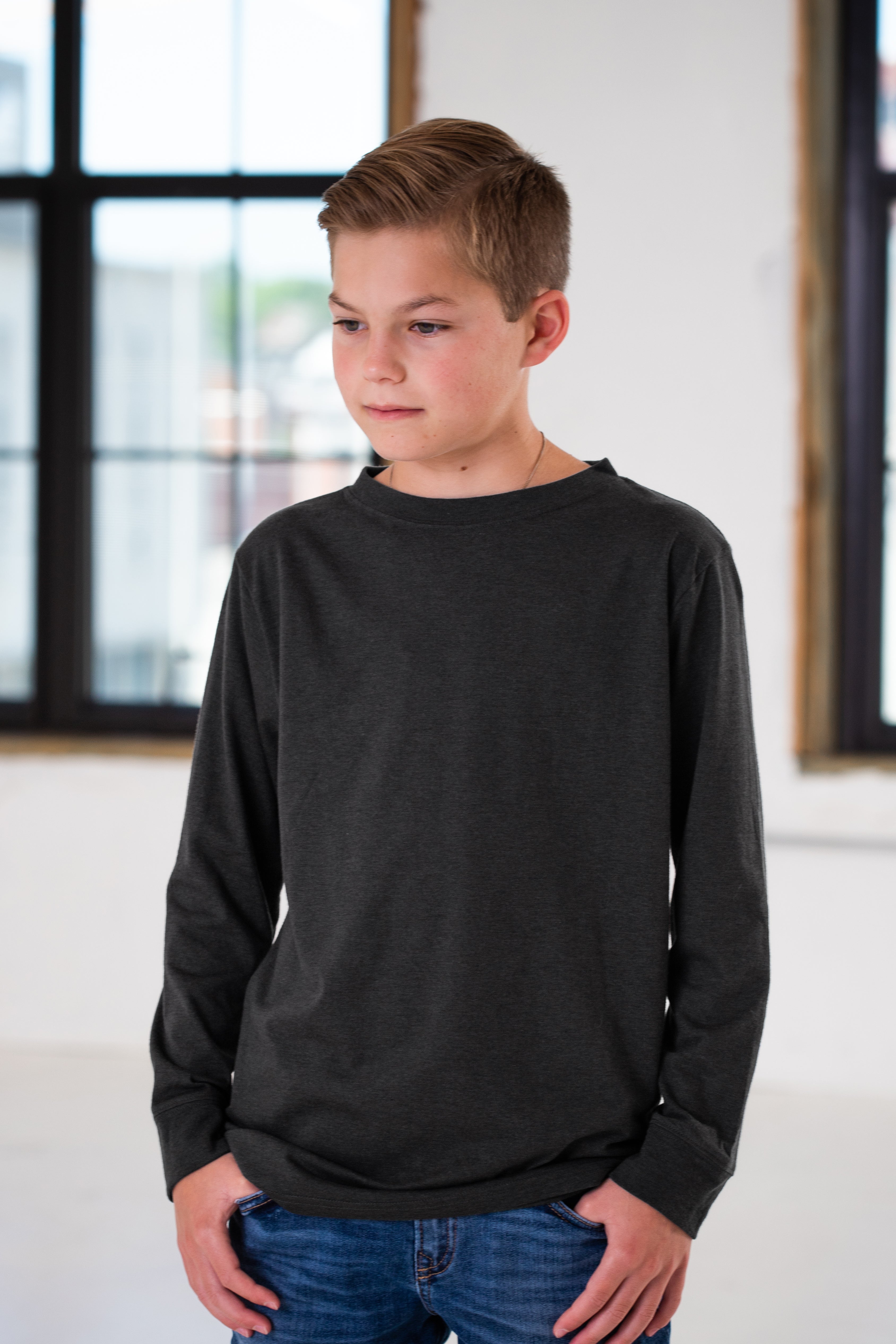 Boy Model wearing GOEX Youth Eco Triblend Long Sleeve Tee in Charcoal