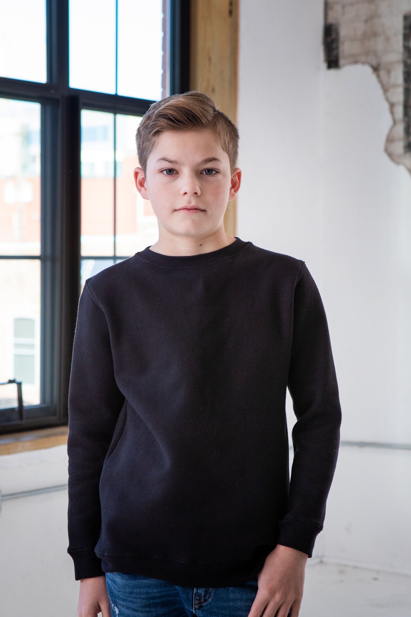 Boy Model wearing GOEX Youth Fleece Crew in Black