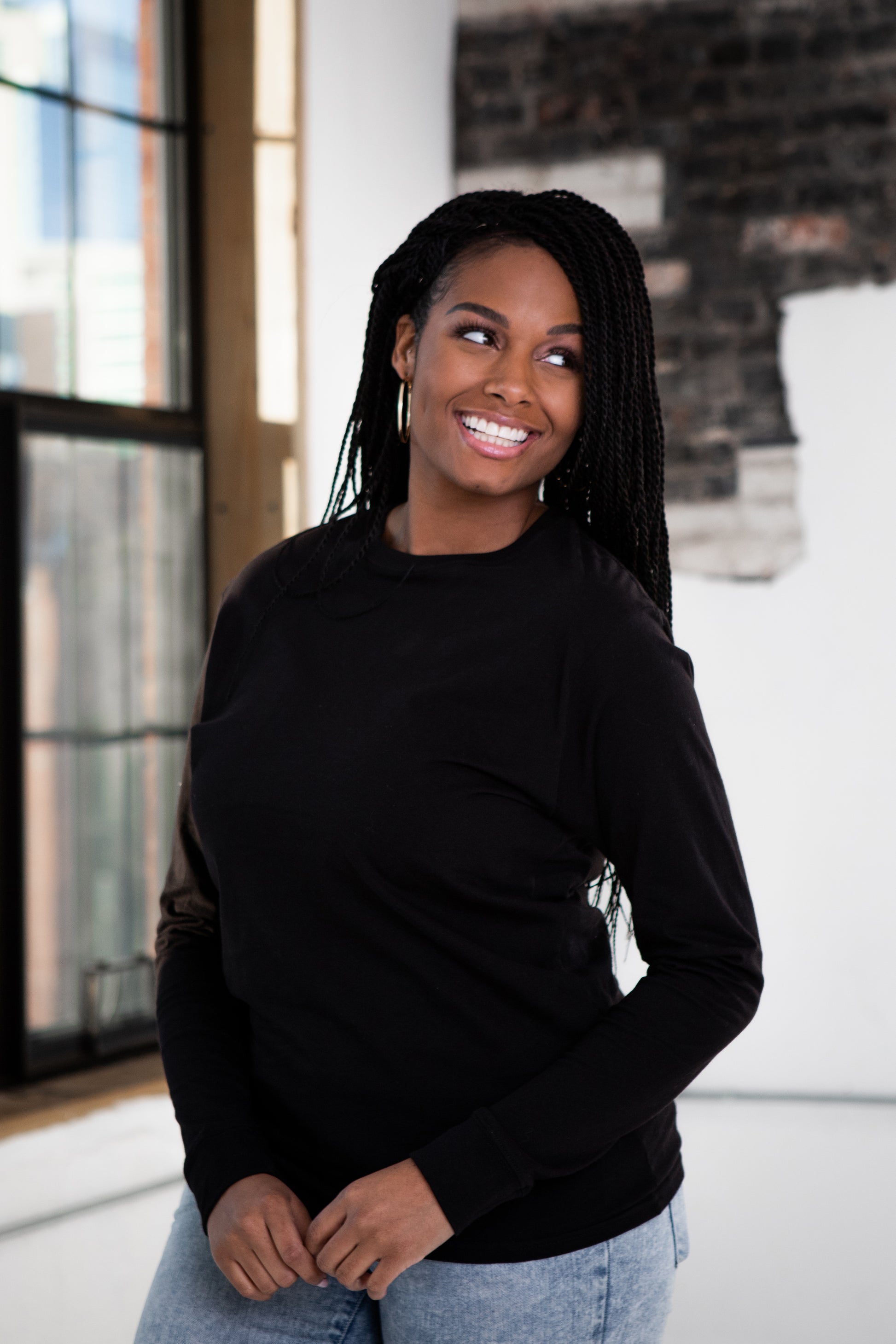 Female Model wearing GOEX Unisex and Men's Premium Cotton LS Tee in Black
