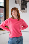 Female Model wearing GOEX Unisex and Men's Fleece Crew in Neon Pink
