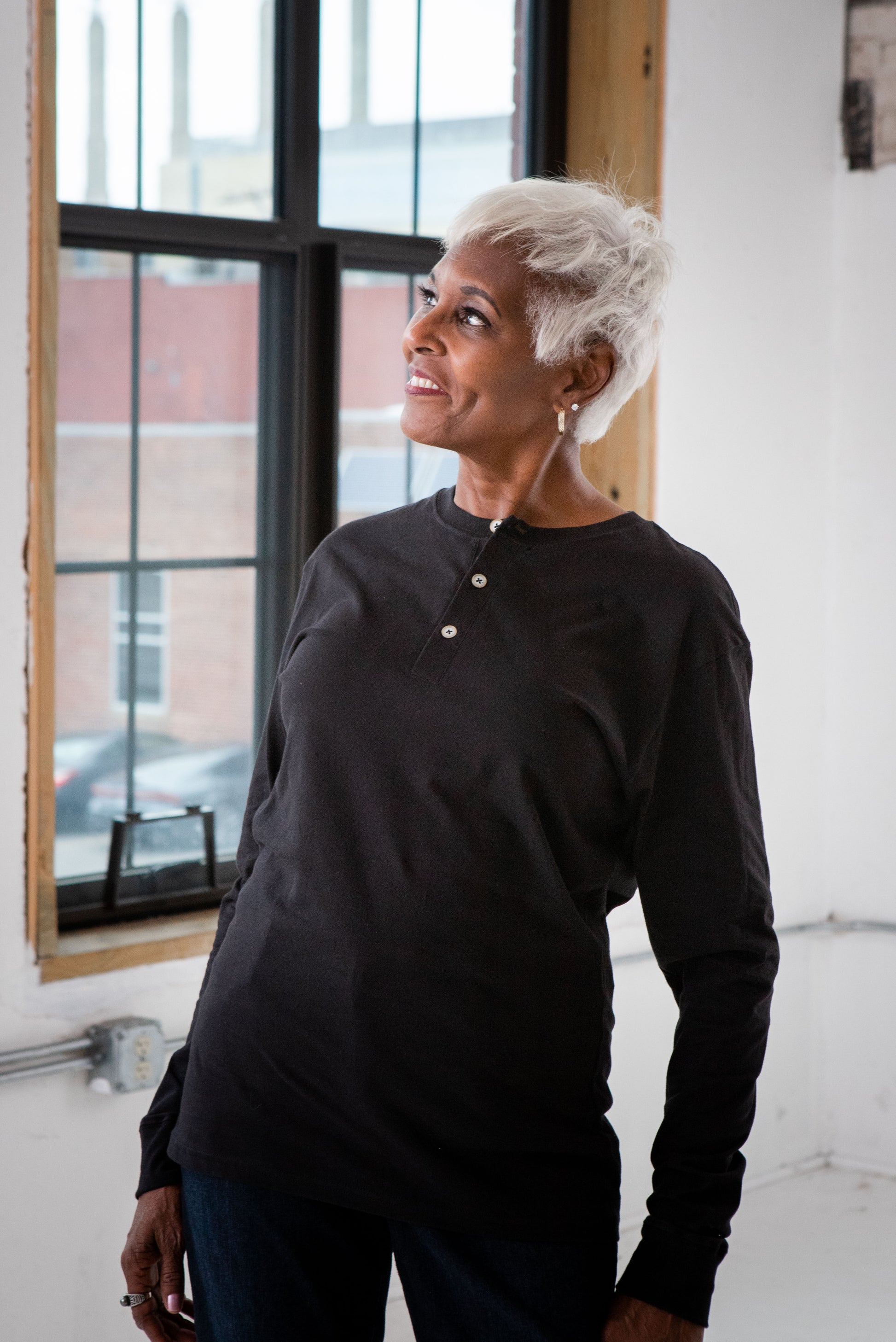 Female Model wearing GOEX Unisex and Men's Eco Cotton Henley in Black