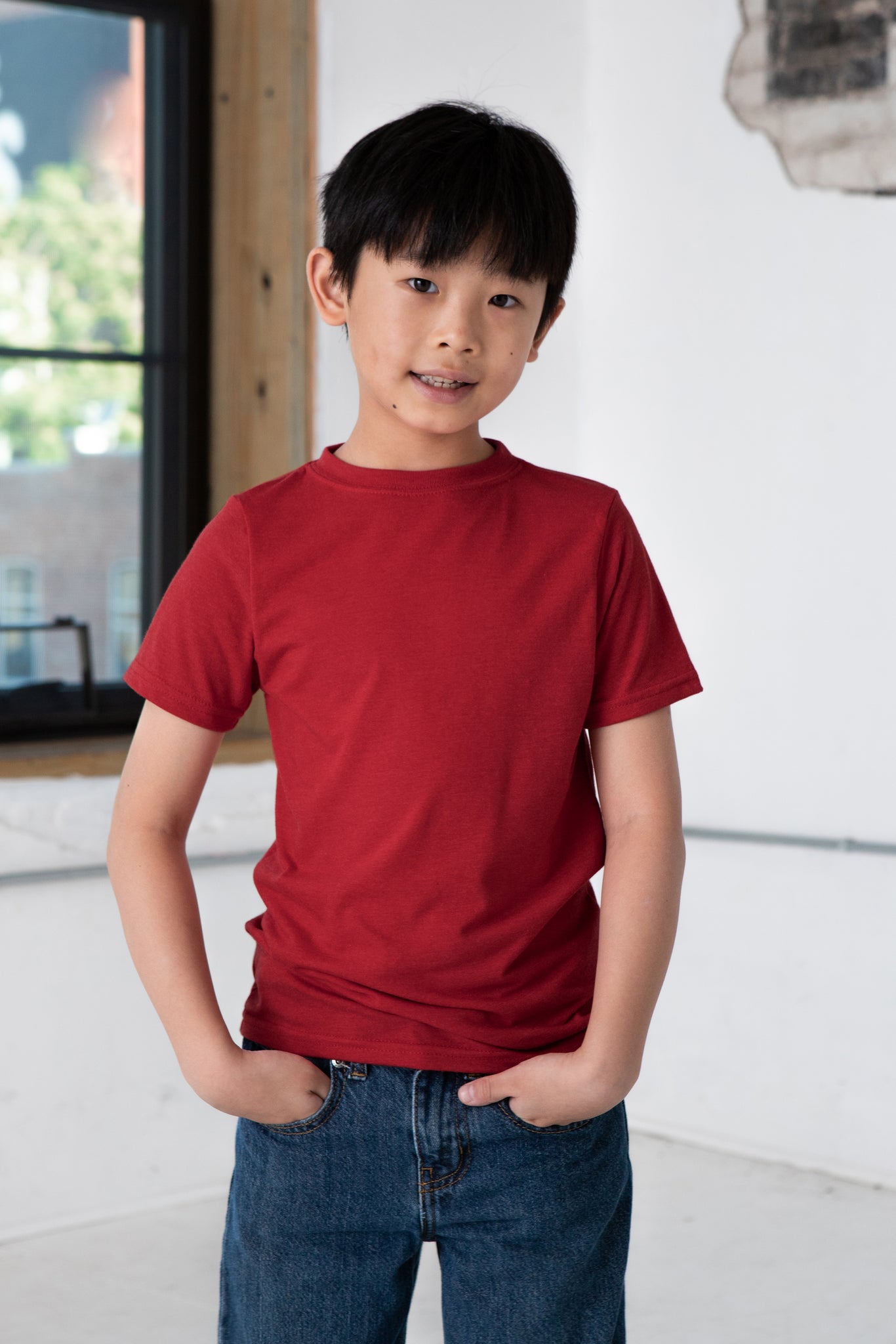 Boy Model wearing GOEX Youth Eco Triblend Tee in Red
