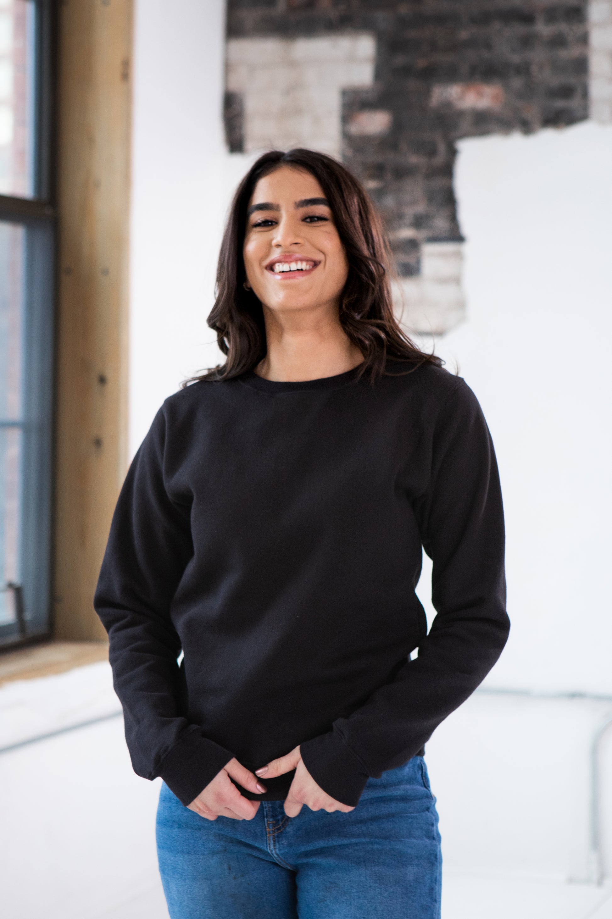 Female Model wearing GOEX Unisex and Men's Fleece Crew in Black