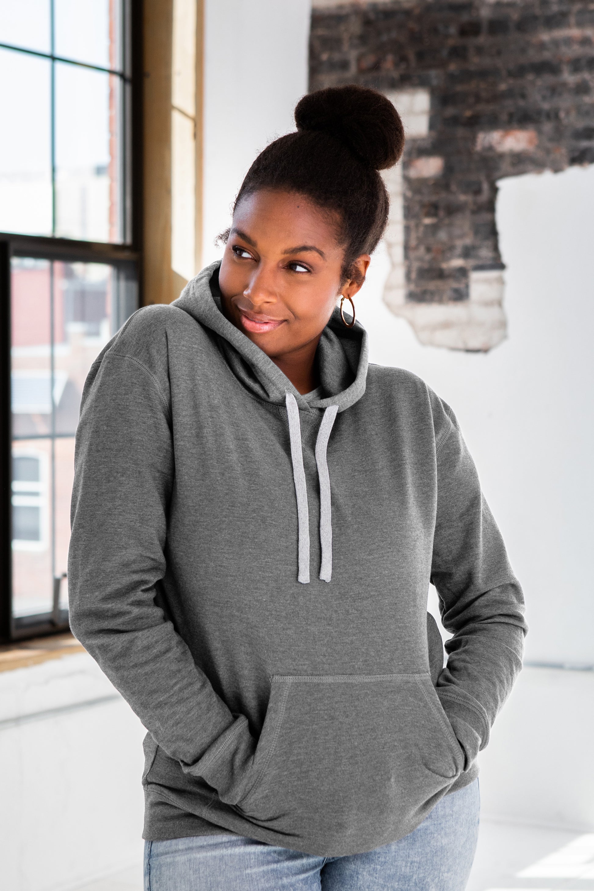 Female Model wearing GOEX Unisex and Men's Fleece Hoodie in Heather Grey