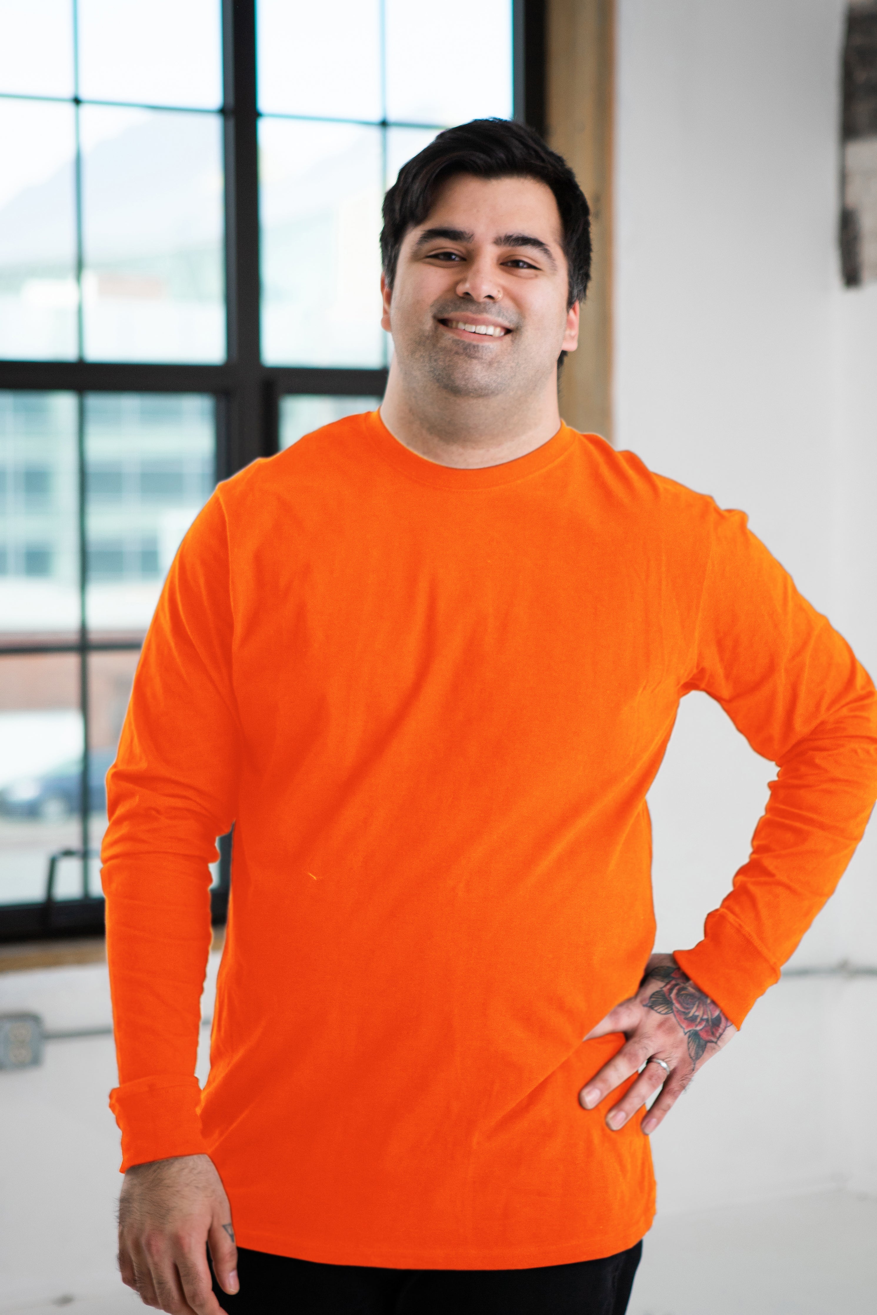 Male Model wearing GOEX Unisex and Men's Premium Cotton LS Tee in Orange
