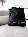 GOEX Feel Good Do Good Black Tote Bag on Chair