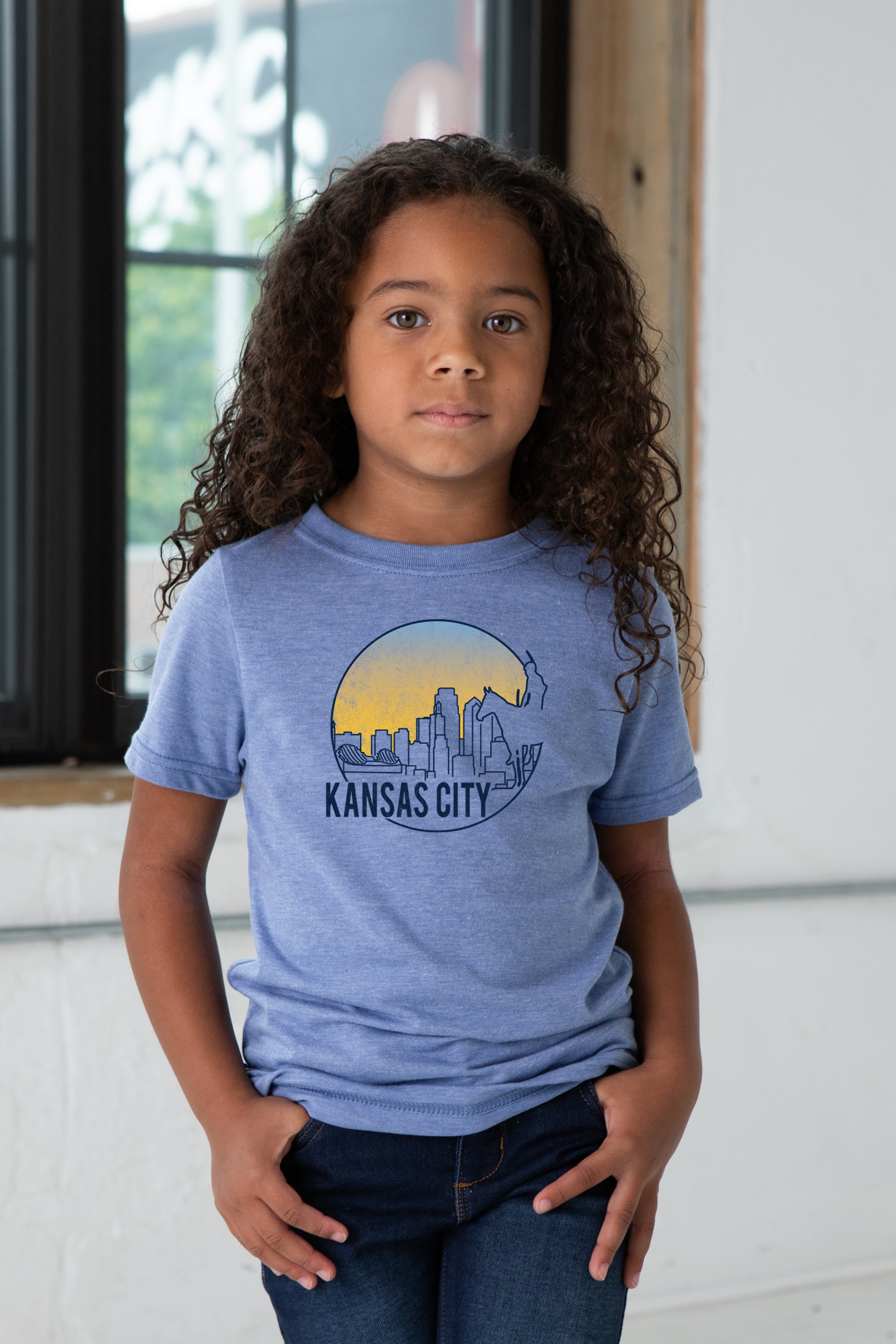 Girl Model wearing GOEX Youth KC Scout Eco Triblend Graphic Tee in Light Blue