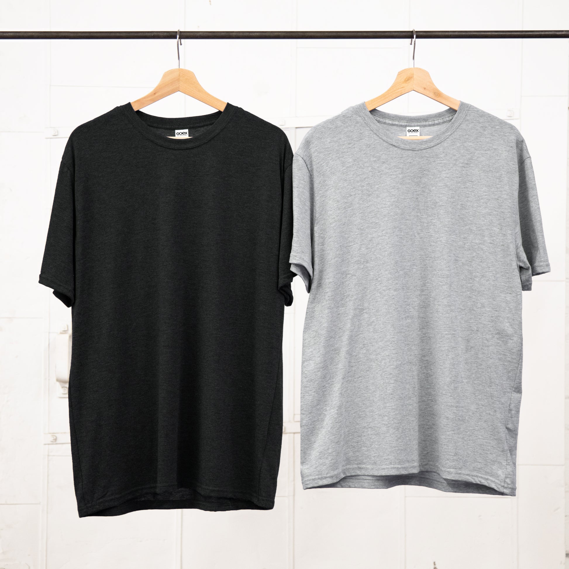 Unisex Tees hanging on a Garment Rack