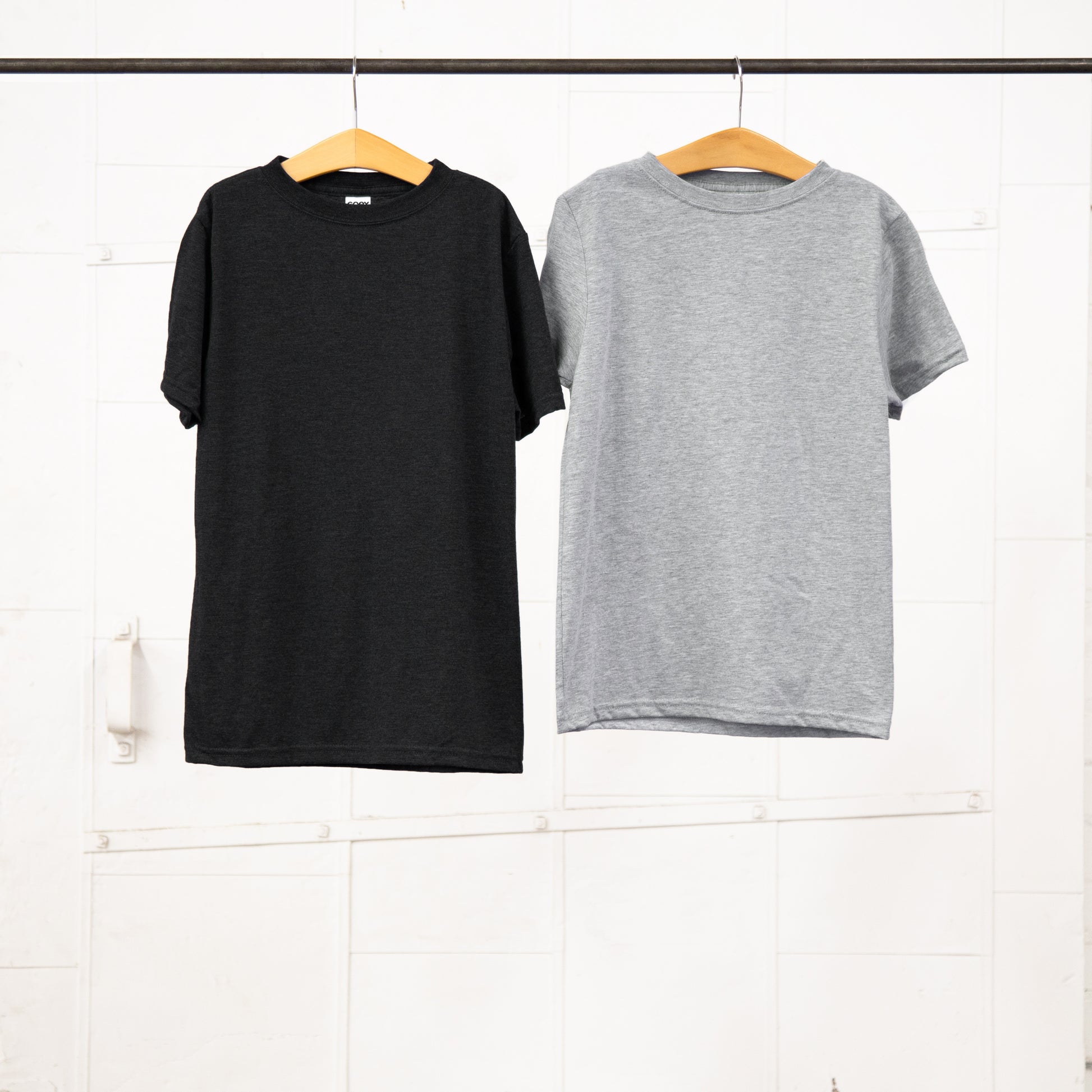 Youth Tees hanging on a garment rack